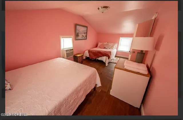 a bed room with two bed and a night stand