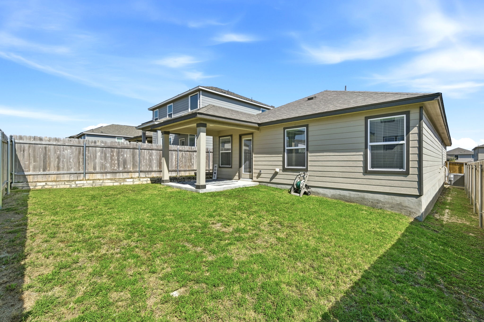 220 Lucky Texan Road Jarrell, TX 76537 - Photo 14 of 19 A well-maintained backyard with a covered patio offers outdoor living space and privacy.