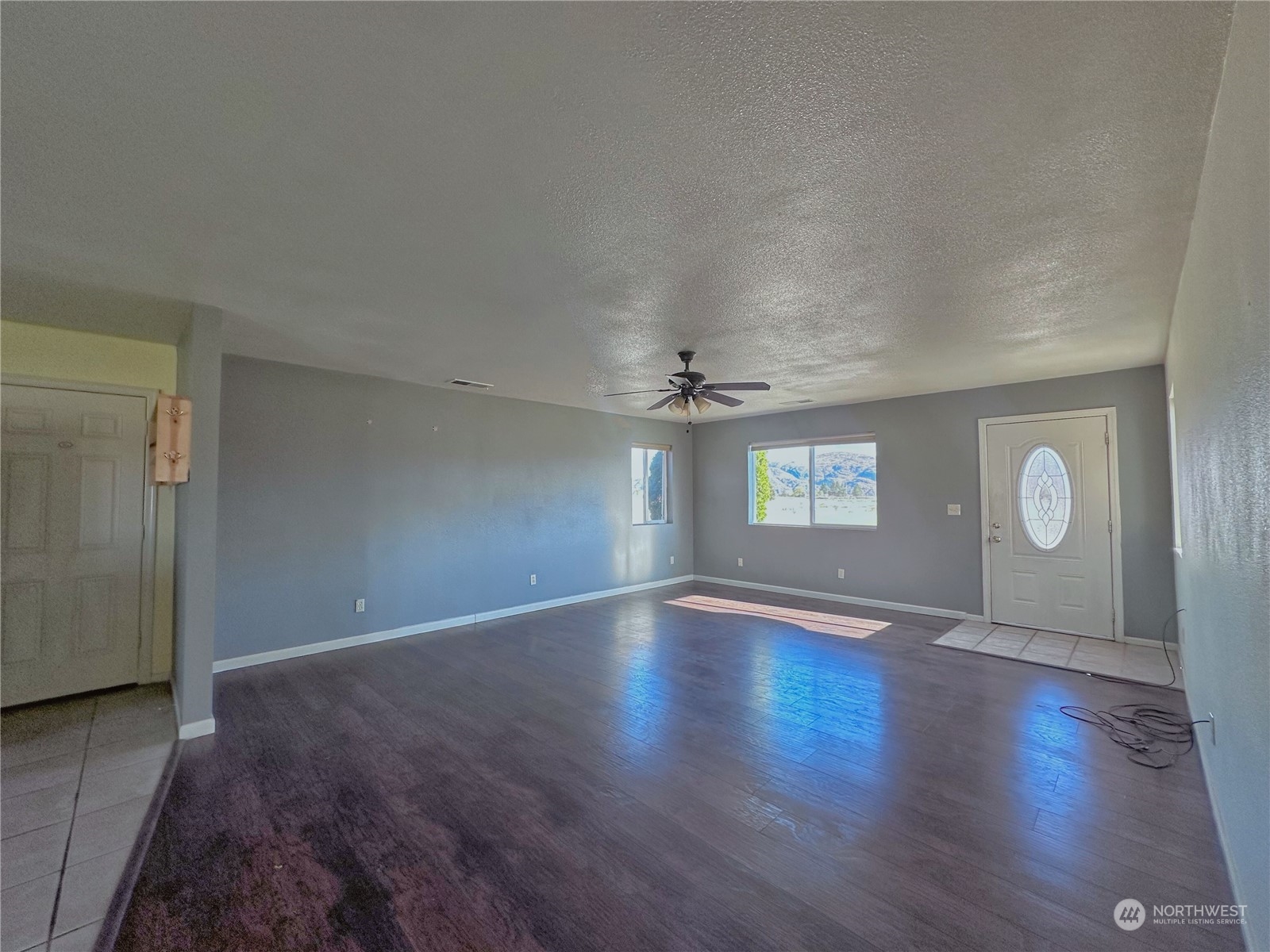 19 Jess Botello Place Riverside, WA 98849 - Photo 4 of 30 an empty room with wooden floor and windows