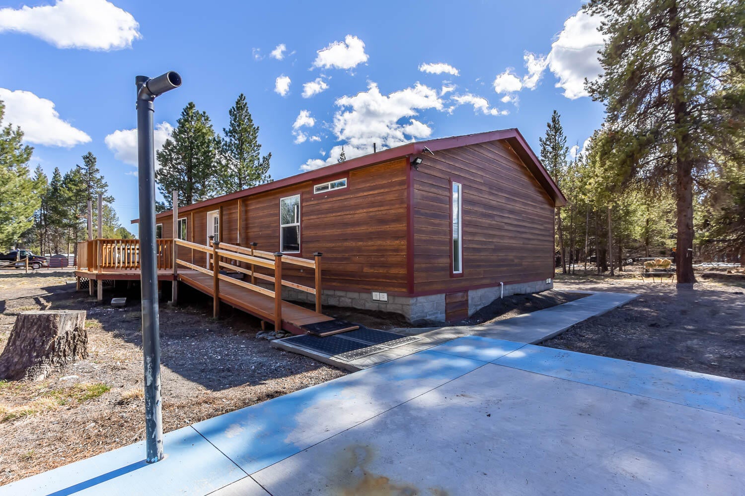 53981 Pine Grove Road La Pine, OR 97739 - Photo 21 of 41 wheelchair accessible ramp on backside of home. Pickleball court is partially showing picture (blue line)