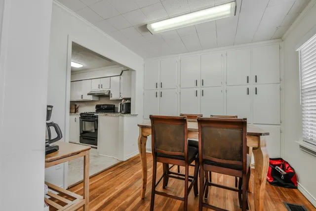 a kitchen with white cabinets and stainless steel appliances