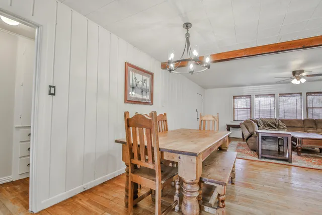 a kitchen with white cabinets and refrigerator