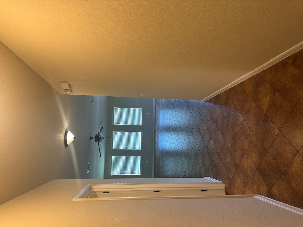7714 Squirrel Hollow Drive Georgetown, TX 78628 - Photo 2 of 17 a view of a hallway with wooden floor and a bathroom