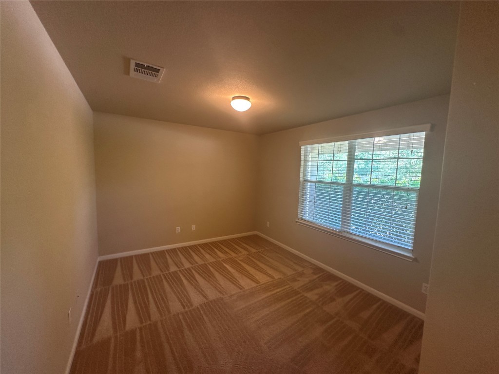 7714 Squirrel Hollow Drive Georgetown, TX 78628 - Photo 3 of 17 a view of an empty room with a window