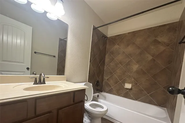 a bathroom with a sink a toilet and a bathtub