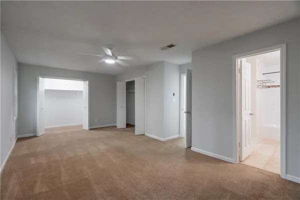 a view of an empty room with a ceiling fan