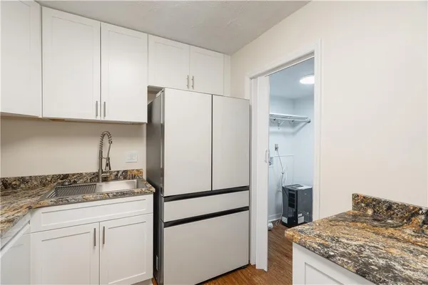 a kitchen with cabinets appliances and a counter space