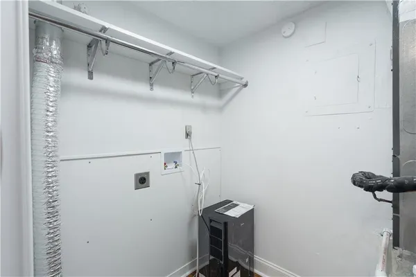 a view of storage and utility room with racks on the wall