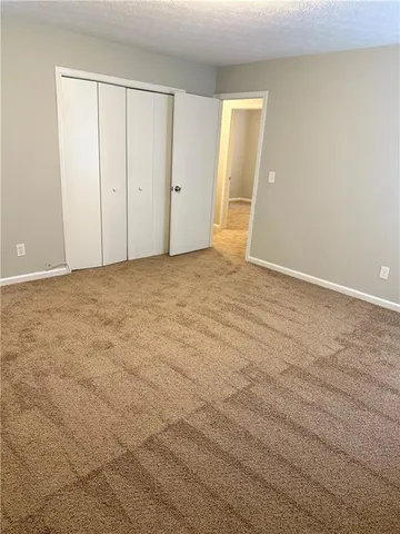 a view of an empty room and wooden floor