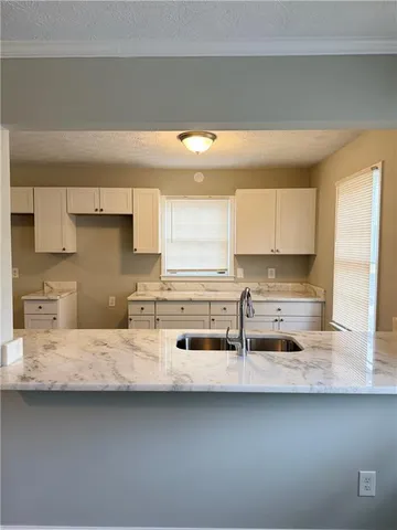 a kitchen with stainless steel appliances a sink and a stove