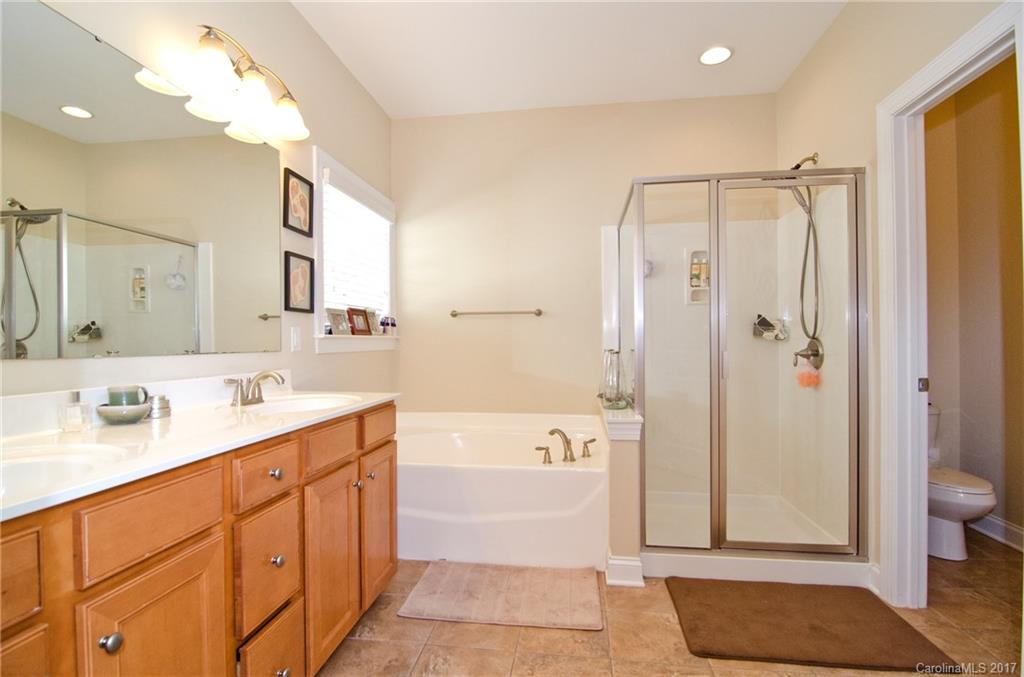 16827 Rudence Court Charlotte, NC 28278 - Photo 12 of 24 a spacious bathroom with a double vanity sink toilet mirror and bathtub
