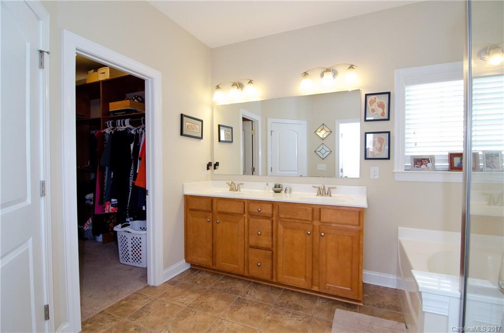 16827 Rudence Court Charlotte, NC 28278 - Photo 13 of 24 a bathroom with a double vanity sink and a mirror
