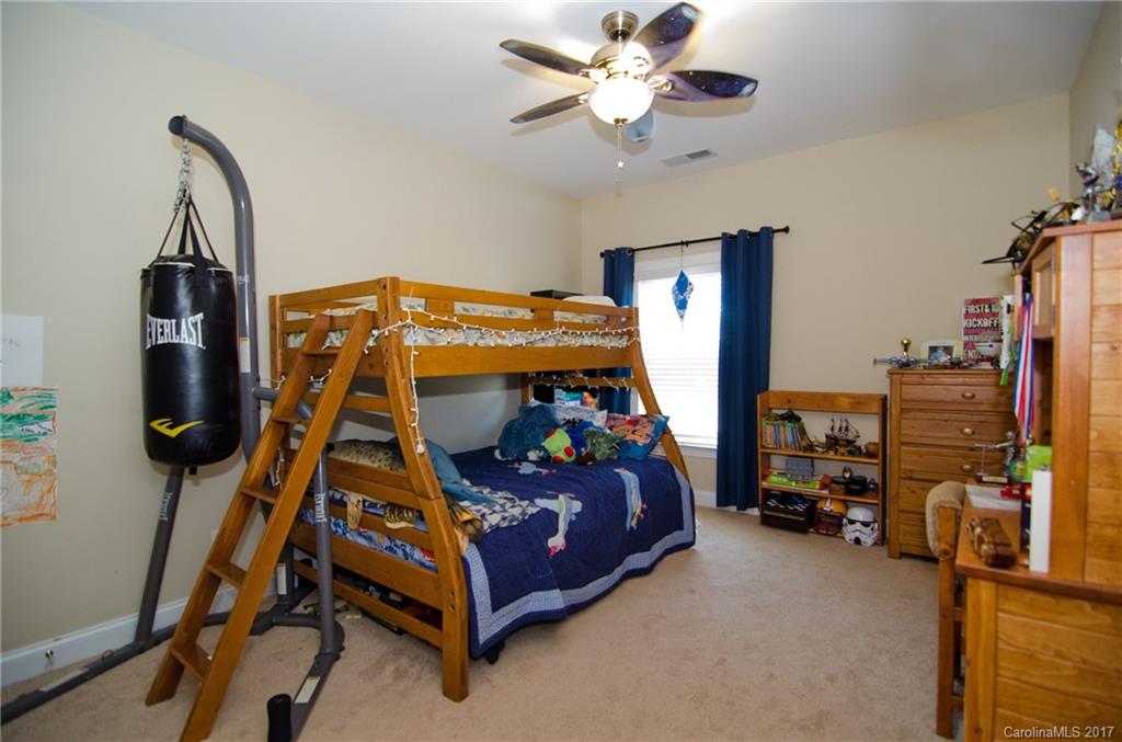 16827 Rudence Court Charlotte, NC 28278 - Photo 15 of 24 a bedroom with a bed and a chandelier