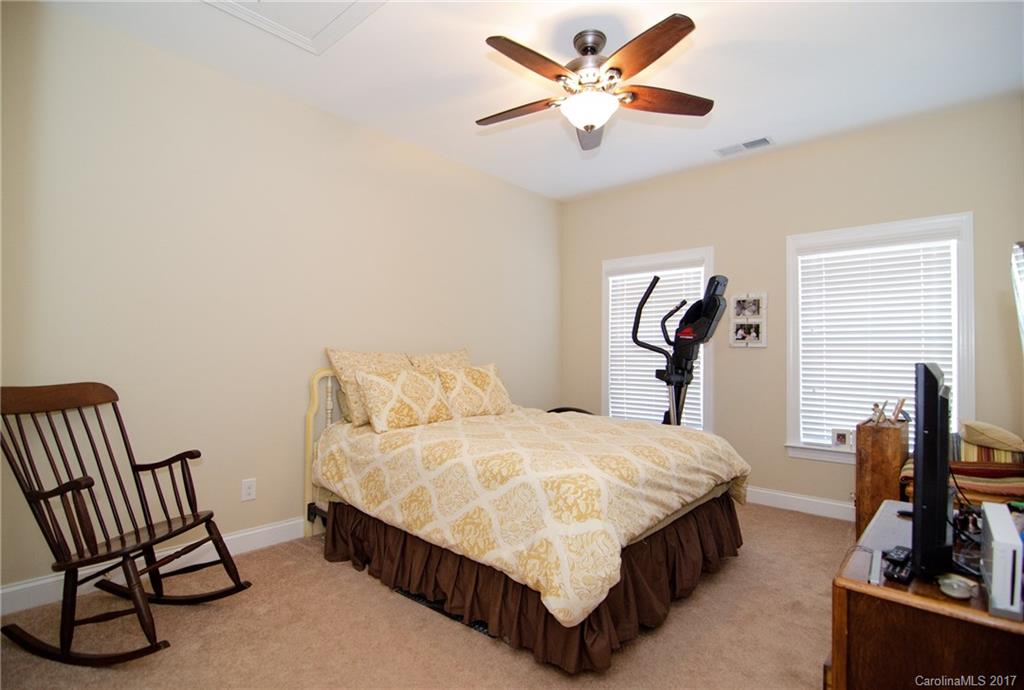 16827 Rudence Court Charlotte, NC 28278 - Photo 16 of 24 a bedroom with a bed and a chandelier