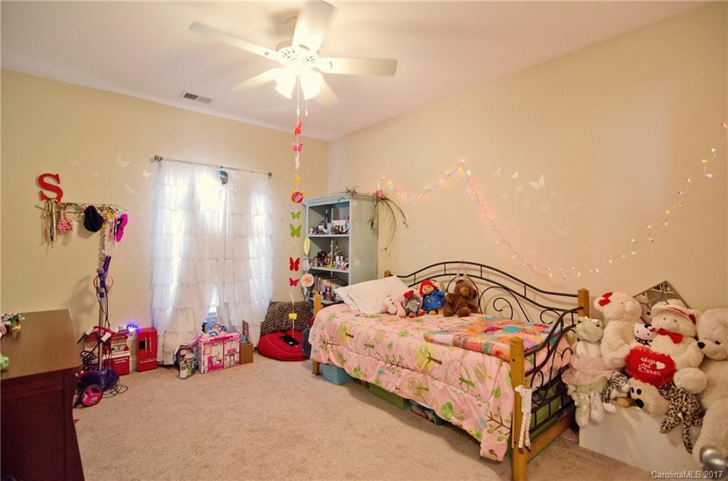 16827 Rudence Court Charlotte, NC 28278 - Photo 17 of 24 a bedroom with furniture and a chandelier