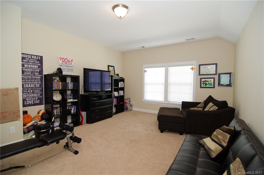 16827 Rudence Court Charlotte, NC 28278 - Photo 18 of 24 a living room with furniture a window and gym equipment