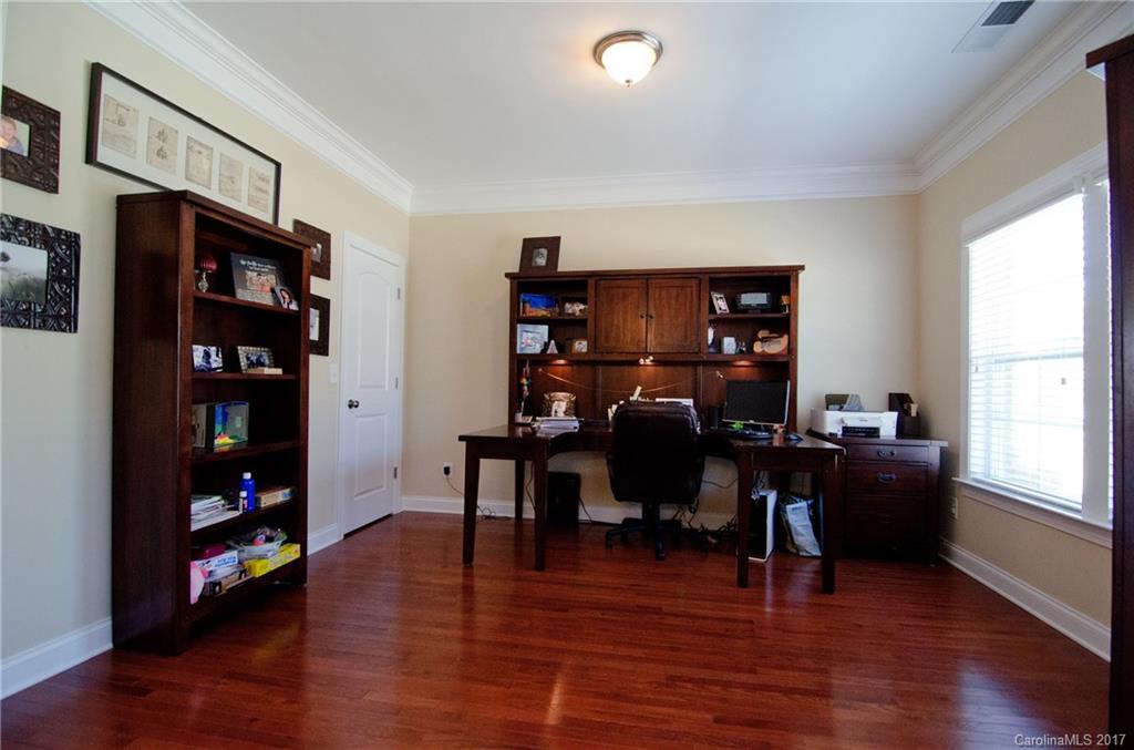 16827 Rudence Court Charlotte, NC 28278 - Photo 3 of 24 a view of a workspace with furniture and a bookshelf