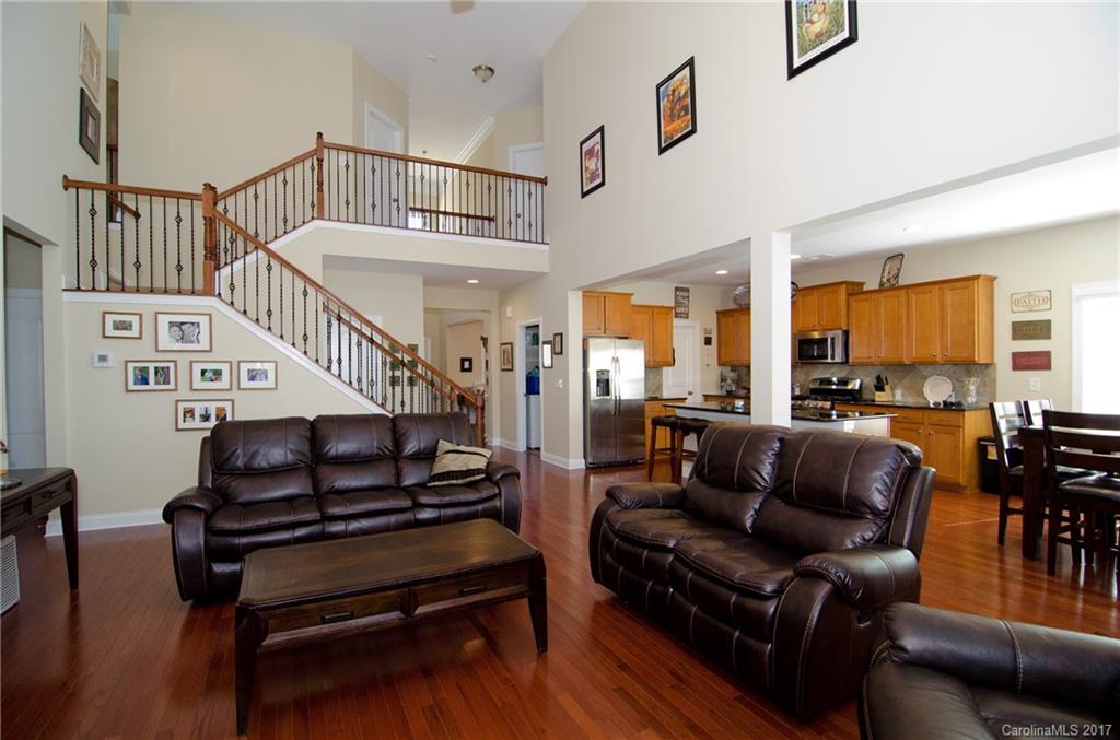 16827 Rudence Court Charlotte, NC 28278 - Photo 6 of 24 a living room with furniture stairs and a wooden floor