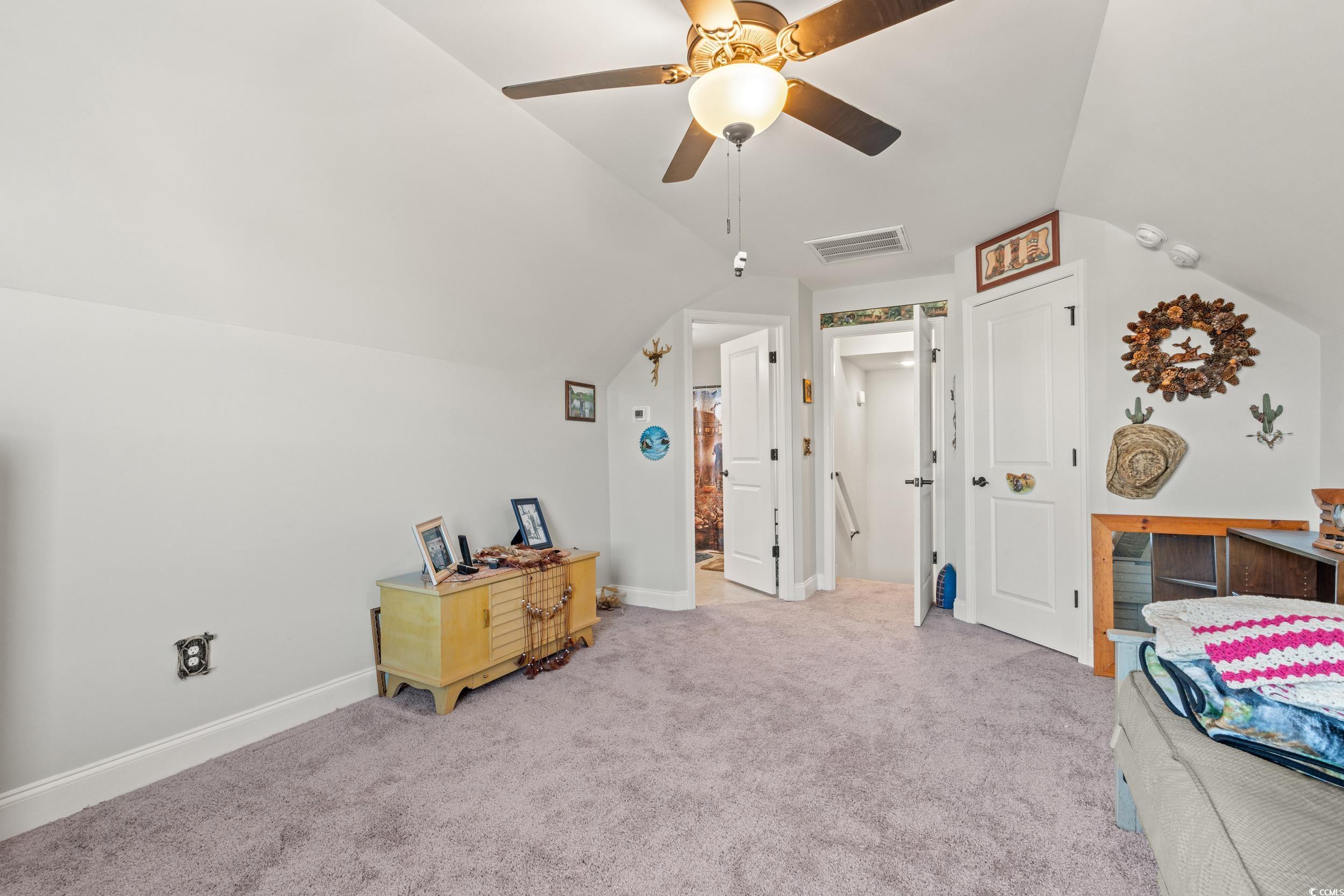 132 Fox Den Drive Murrells Inlet, SC 29576 - Photo 17 of 35 Carpeted bedroom with lofted ceiling and ceiling fan