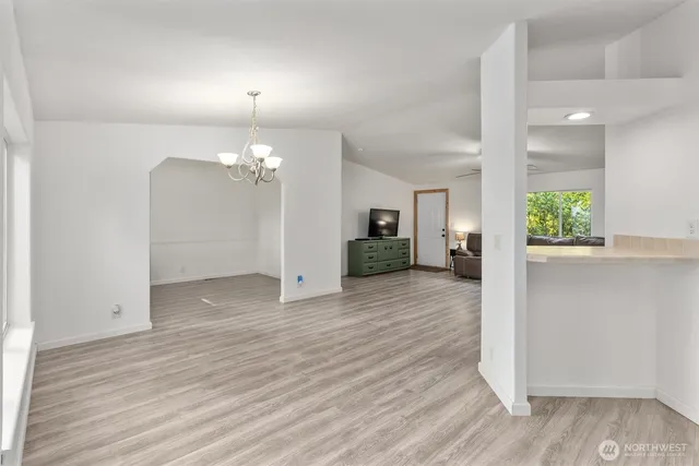 a view of a room with wooden floor