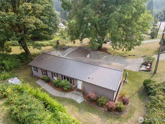 an aerial view of a house with yard and green space