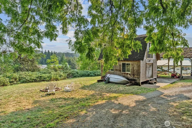 a view of a backyard with a small cabin