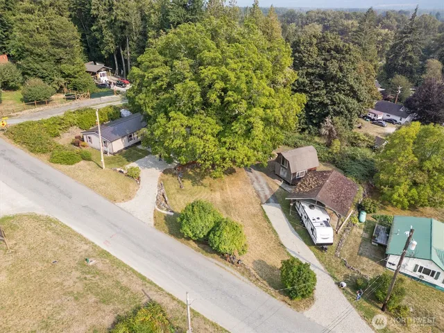 an aerial view of a house with a yard and lake view