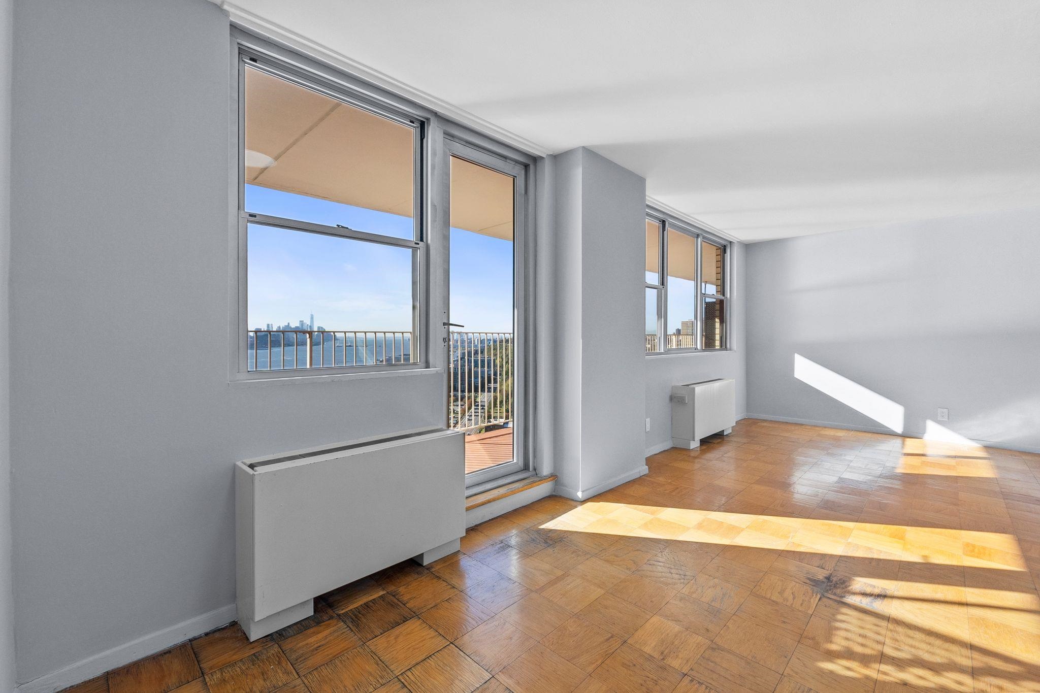 6040 Boulevard East, Unit 14F West New York, NJ 07093 - Photo 11 of 34 a kitchen with stainless steel appliances granite countertop a refrigerator and a stove top oven