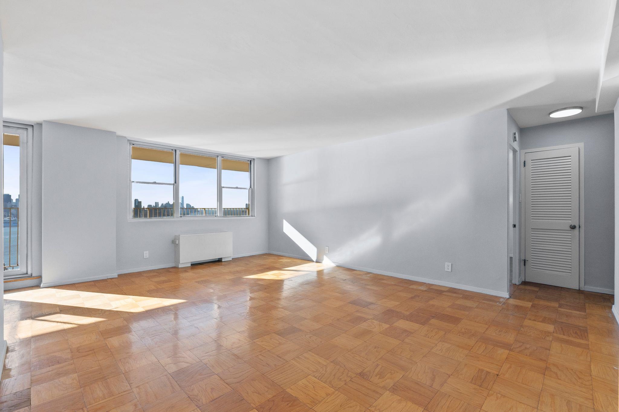 6040 Boulevard East, Unit 14F West New York, NJ 07093 - Photo 16 of 34 a view of an empty room with a window