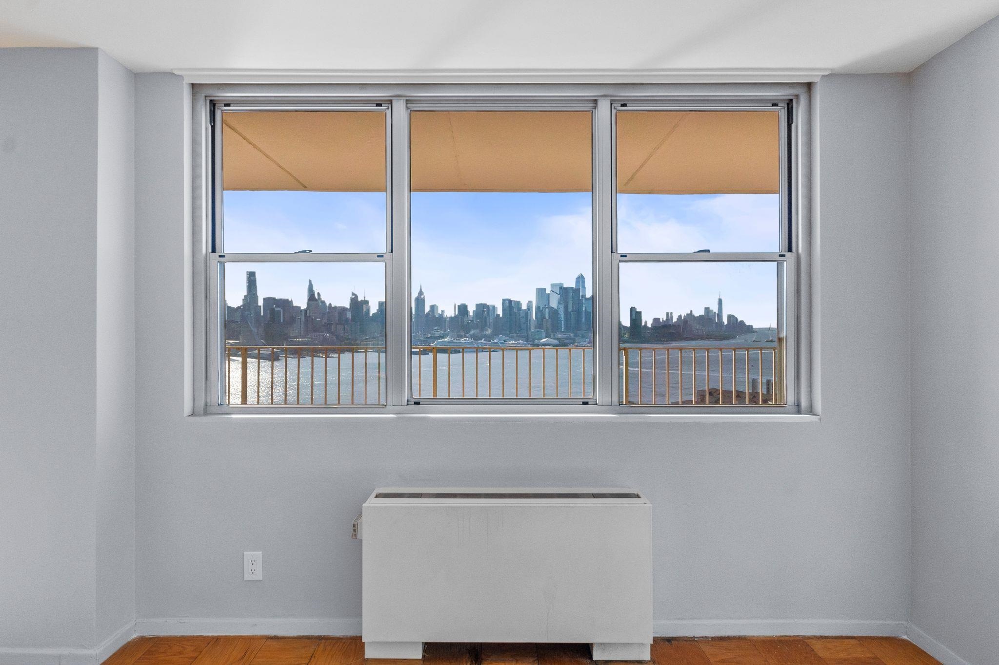 6040 Boulevard East, Unit 14F West New York, NJ 07093 - Photo 17 of 34 a view of a room that has a bed and a window