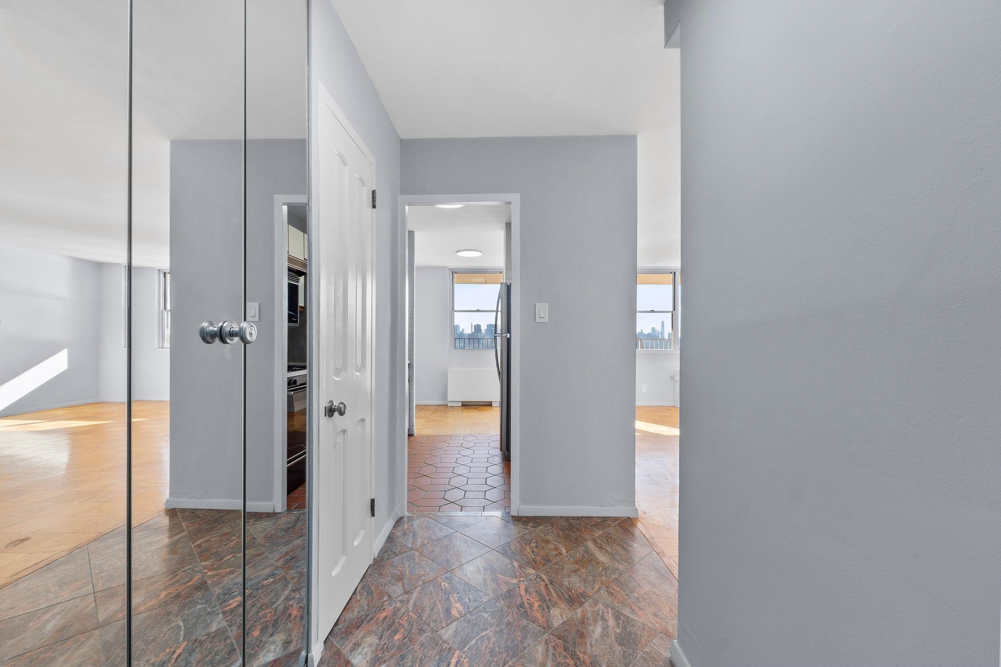 6040 Boulevard East, Unit 14F West New York, NJ 07093 - Photo 6 of 34 wooden floor with white walls