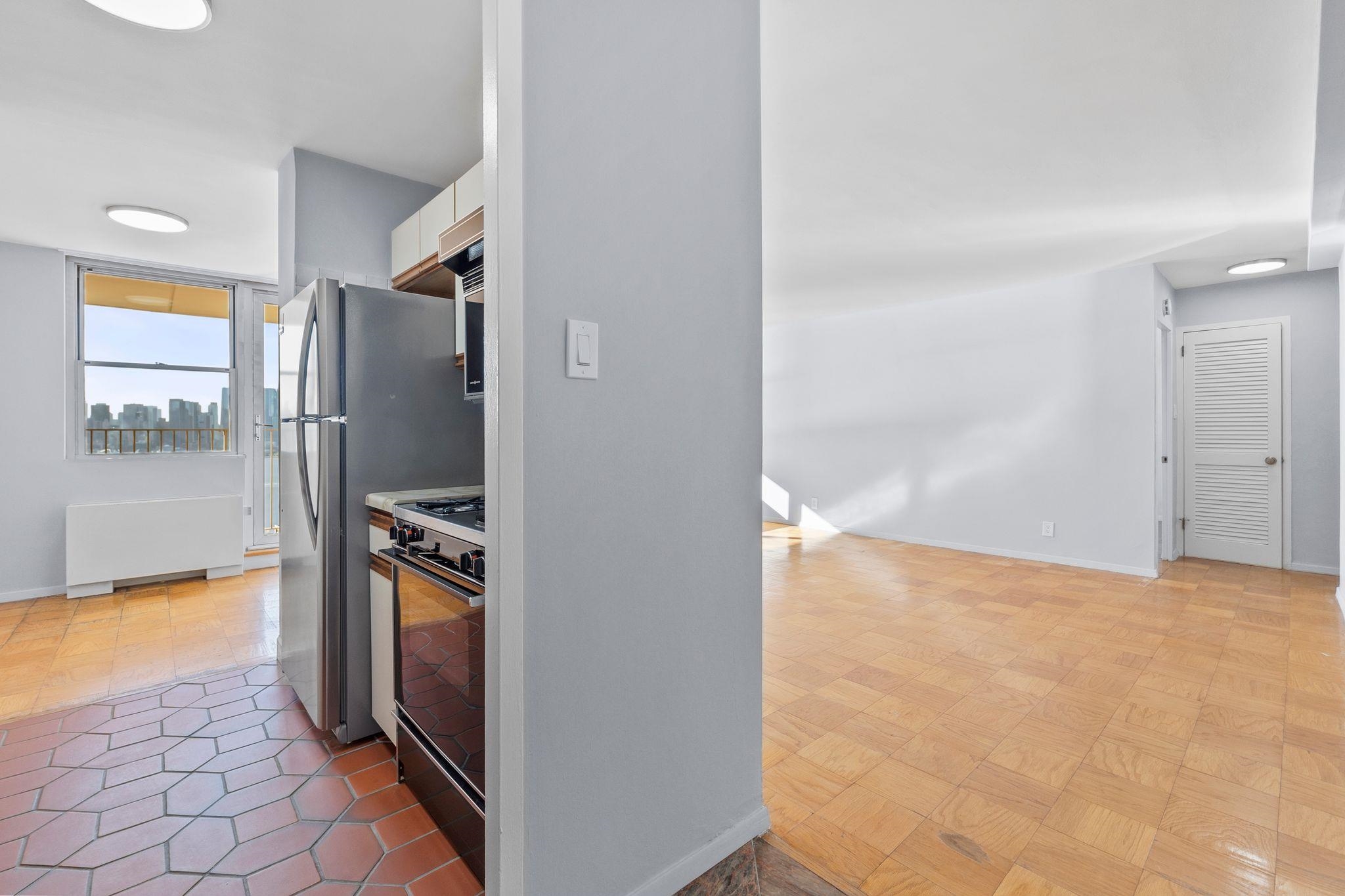 6040 Boulevard East, Unit 14F West New York, NJ 07093 - Photo 7 of 34 a view of a kitchen from the hallway