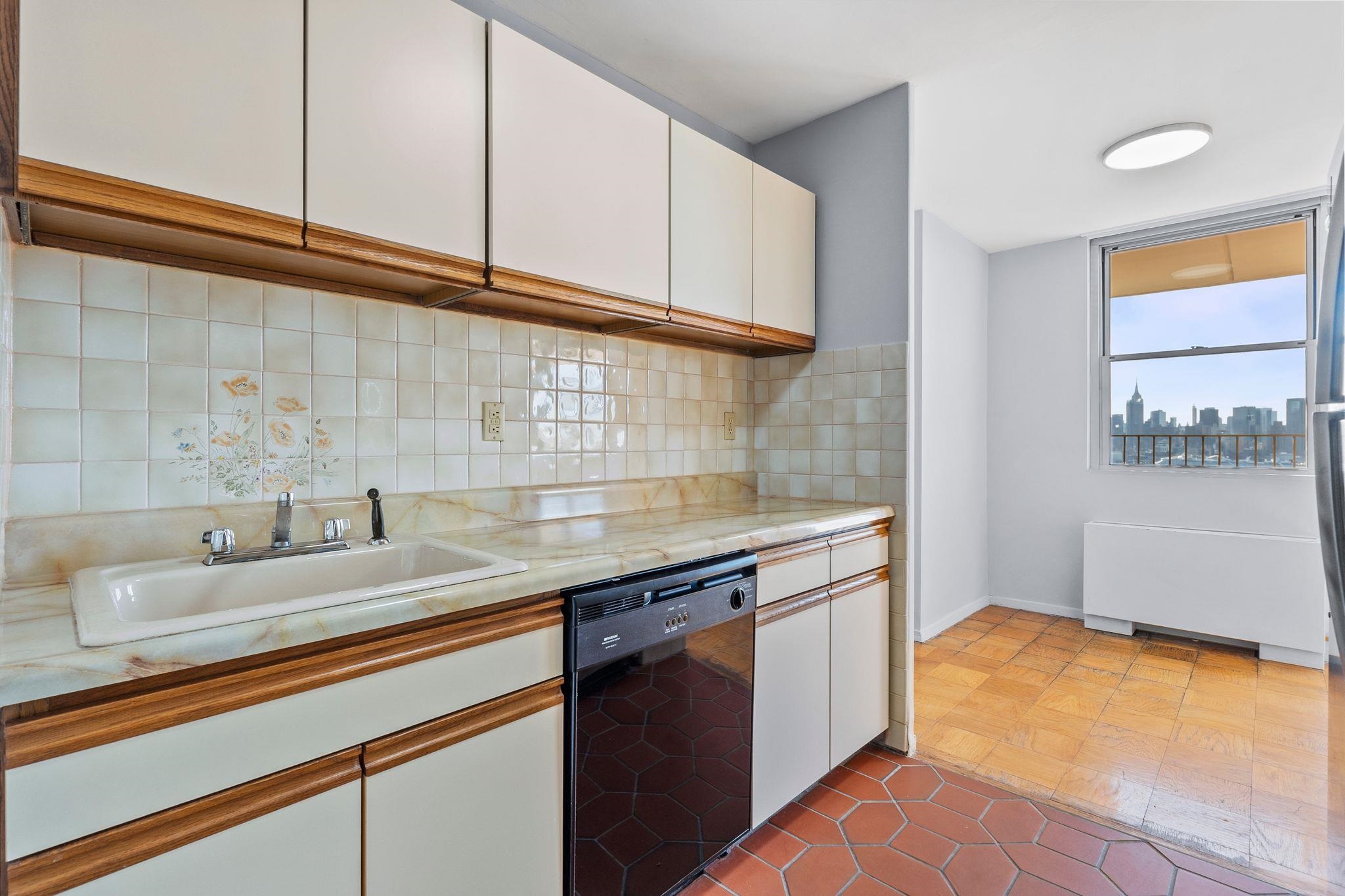6040 Boulevard East, Unit 14F West New York, NJ 07093 - Photo 8 of 34 a kitchen with a sink and cabinets