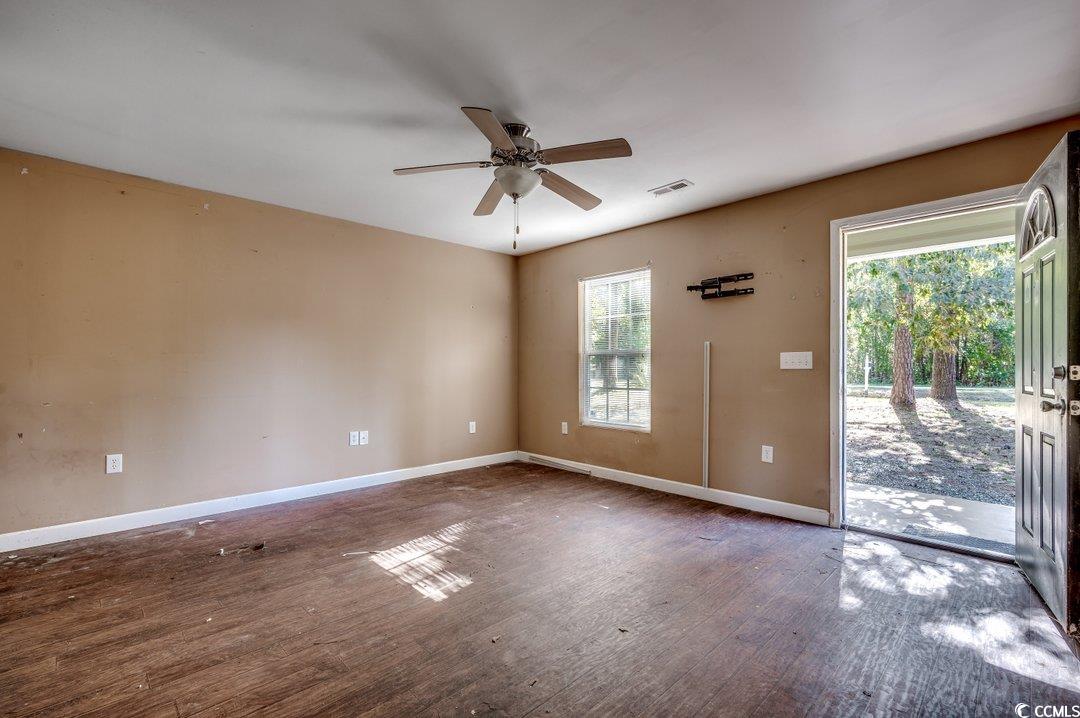 5221 Bottle Branch Road Conway, SC 29527 - Photo 3 of 16 Empty room featuring ceiling fan, a wealth of natu