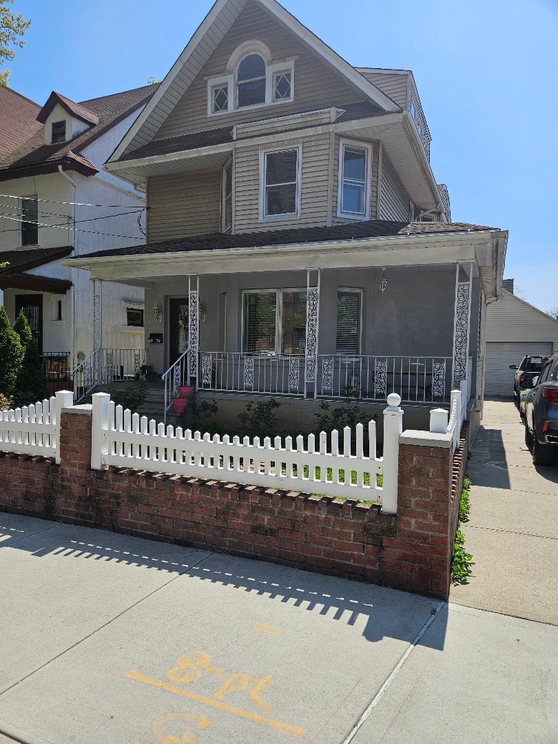 84-24 85th Road Queens, NY 11421 - Photo 2 of 10 a front view of a house with a garden