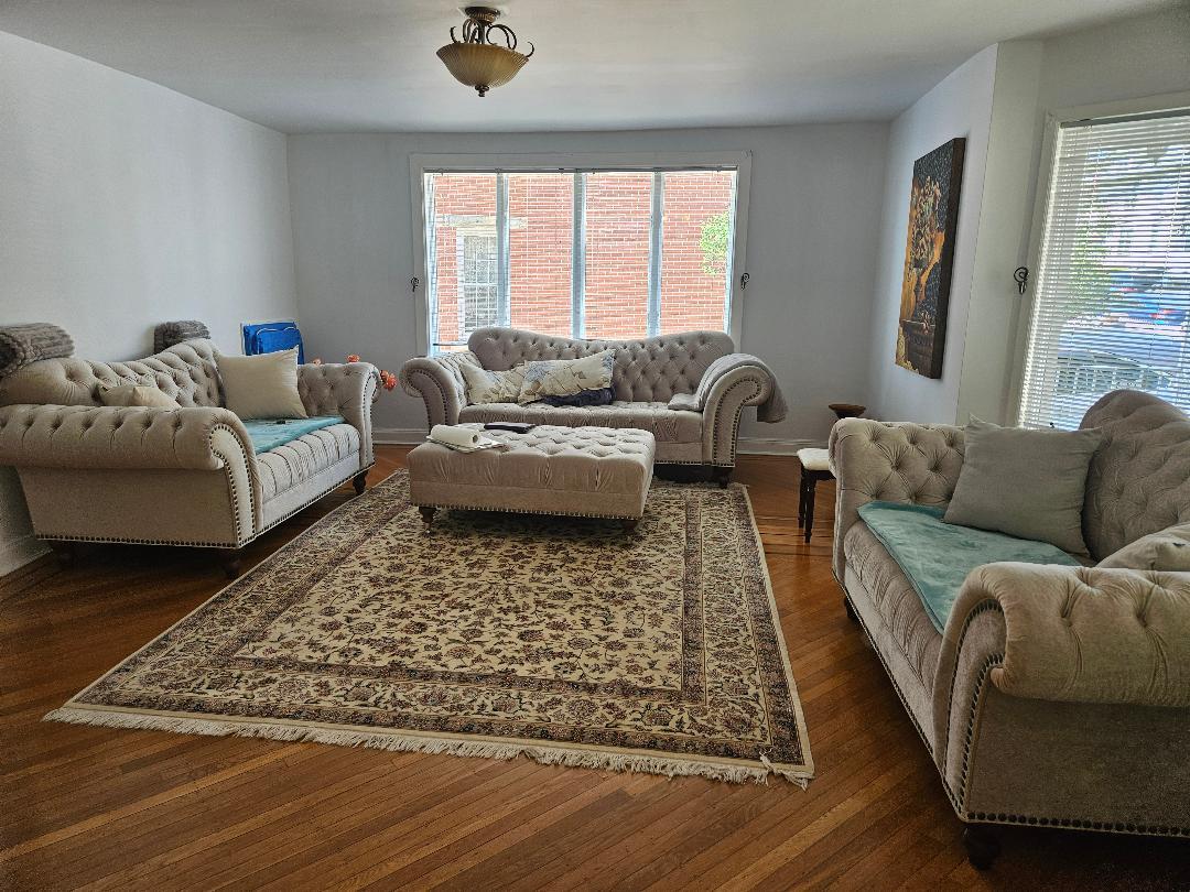 84-24 85th Road Queens, NY 11421 - Photo 3 of 10 a living room with furniture and a rug