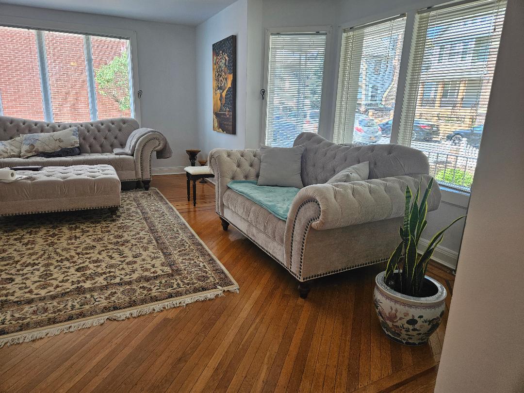84-24 85th Road Queens, NY 11421 - Photo 4 of 10 a living room with furniture and a rug