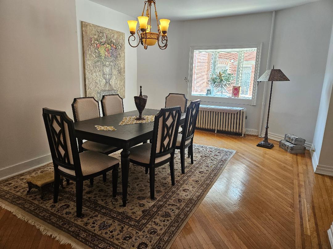84-24 85th Road Queens, NY 11421 - Photo 5 of 10 a view of a dining room with furniture and a chandelier