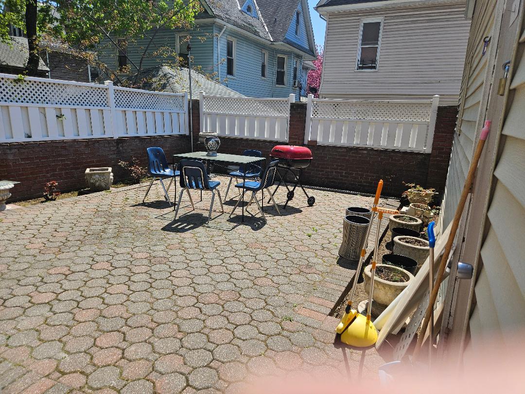 84-24 85th Road Queens, NY 11421 - Photo 8 of 10 a view of a dinning table and chairs in the patio