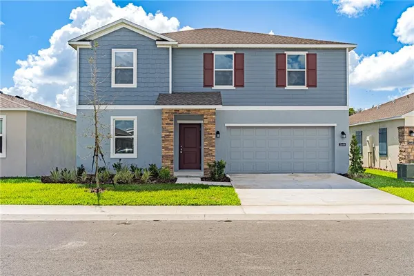 a house that has a big yard in front of it