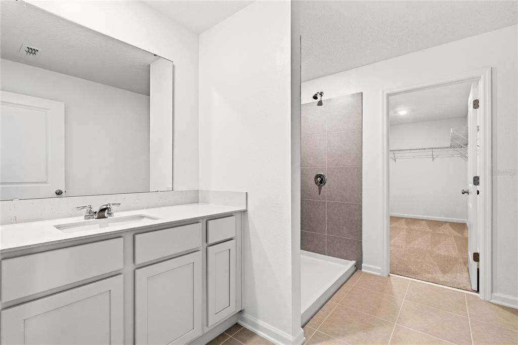 3644 Rolling Rdg Bend Davenport, FL 33837 - Photo 15 of 31 a bathroom with a shower sink and mirror