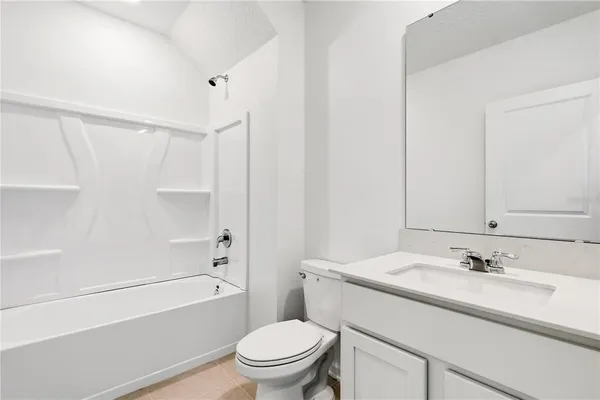 a bathroom with a sink toilet vanity and shower
