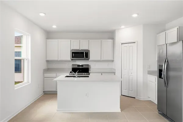 a kitchen with a refrigerator stove and microwave