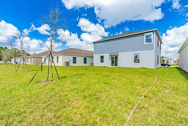 a view of a house with a backyard