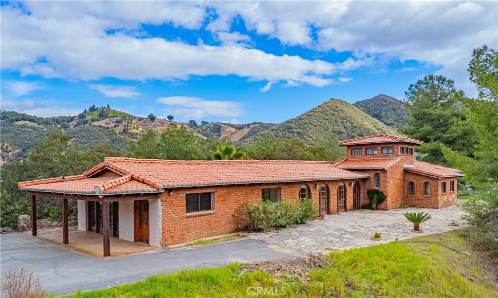 a front view of a house with a garden and yard