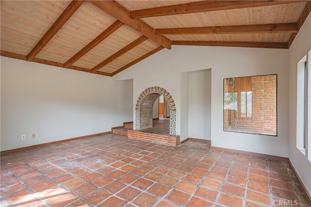 48703 De Luz Road Temecula, CA 92590 - Photo 11 of 36 a view of an empty room with a fireplace and a window