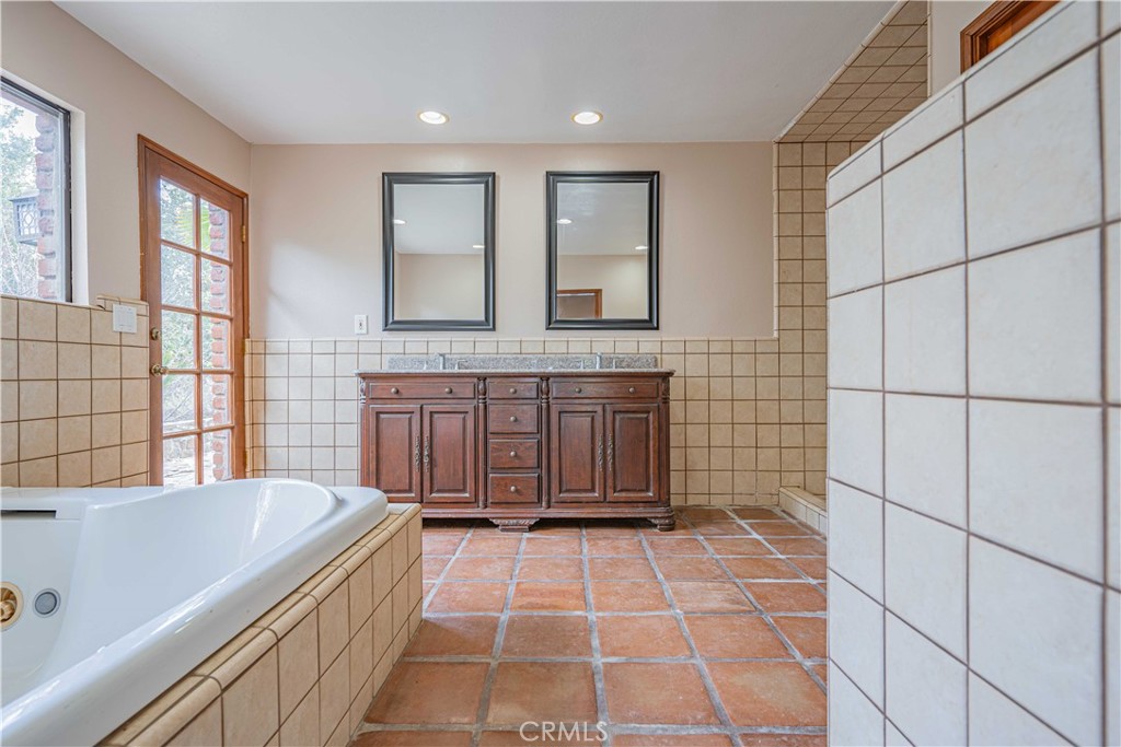 48703 De Luz Road Temecula, CA 92590 - Photo 23 of 36 a spacious bathroom with a tub and a sink