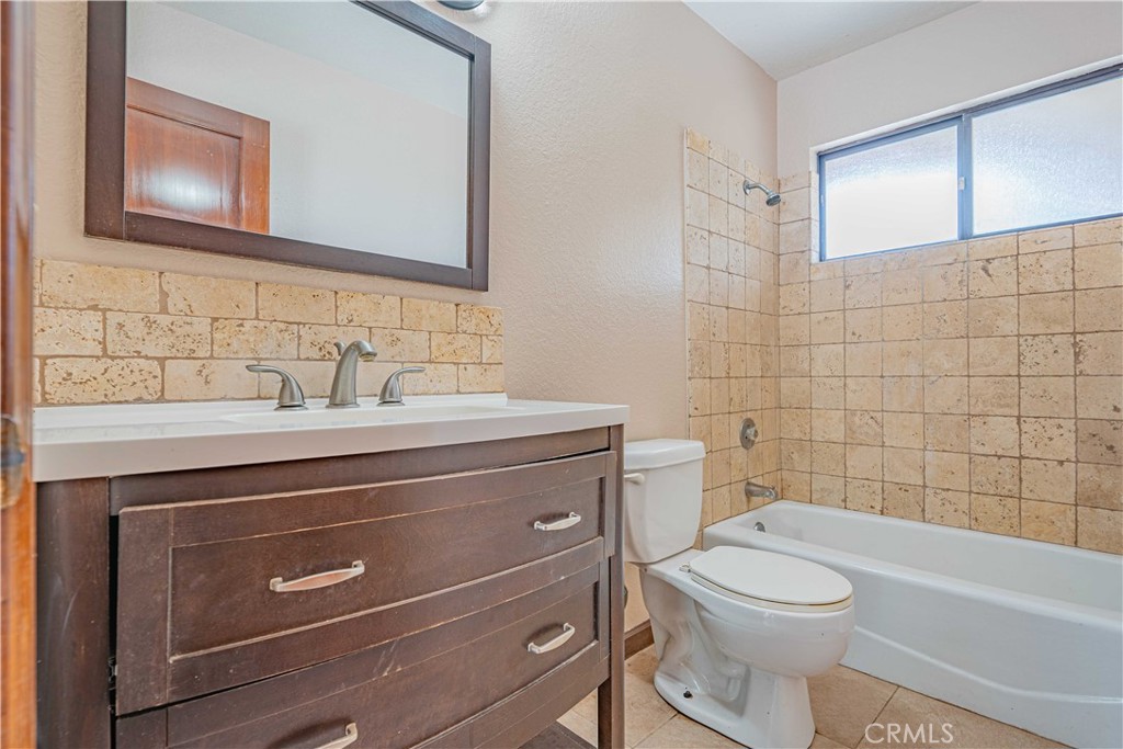 48703 De Luz Road Temecula, CA 92590 - Photo 27 of 36 a bathroom with a sink a toilet and shower