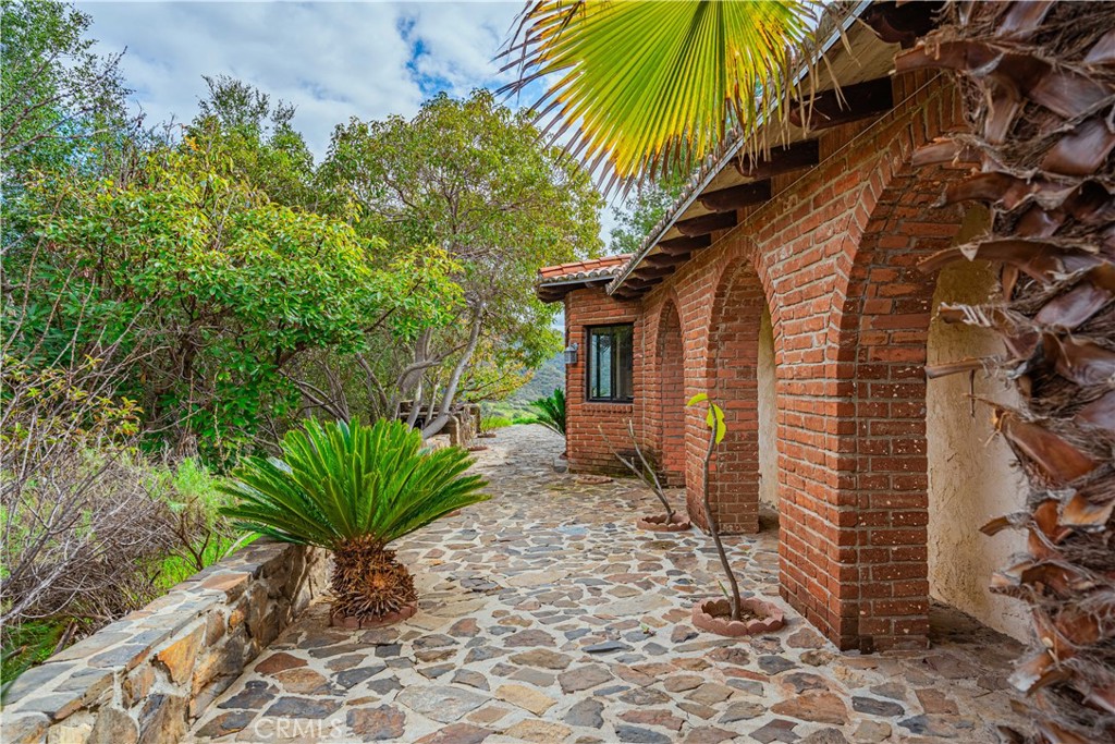 48703 De Luz Road Temecula, CA 92590 - Photo 35 of 36 a house with a plant in front of it