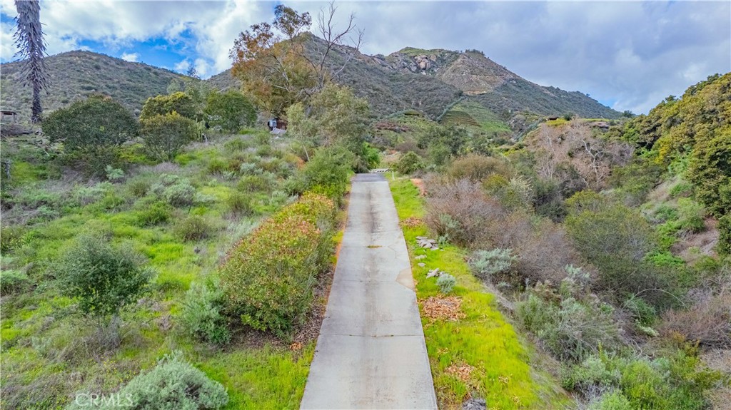 48703 De Luz Road Temecula, CA 92590 - Photo 7 of 36 a view of a pathway with a garden